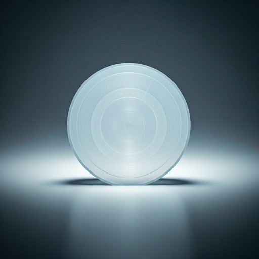Translucent molded plastic component lit on a dark studio surface